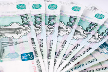 A stack of thousand-ruble banknotes, spread out money. Russian currency on a white background.
