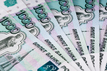 A stack of thousand-ruble banknotes, spread out money. Russian currency on a white background.