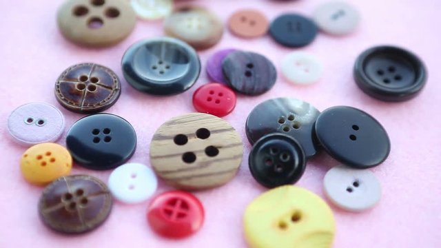 various colorful buttons on pink rotating table
