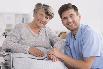Happy elderly woman with male nurse