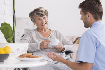 Obraz na płótnie Canvas Senior drinking tea in nursing home