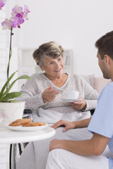 Obraz na płótnie Canvas Grandmother talking with caregiver