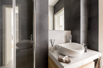 Fototapeta na wymiar Grey bathroom with mirror