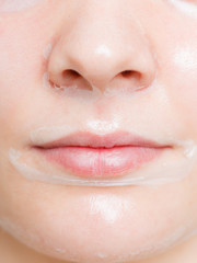 Fototapeta premium Close up woman in facial peel off mask.
