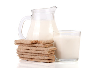 jug and glass of milk with grain crispbreads isolated on white background
