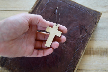Cross in hand over bible