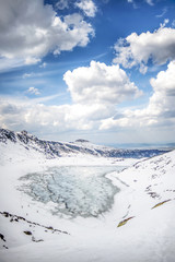 Winter landscape of frozen mountaind pond, Czarny staw gąsienicowy, Tatry mountains. Beautiful sunny day. Vertical. © Kozioł Kamila
