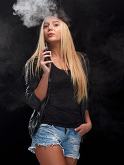 Fototapeta premium Young sexy blond woman is vaping.