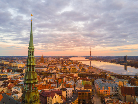 Beautiful aerial view of the St. Peters cathedral in Riga with a highest tower in Europe - TV tower by the Daugava river.