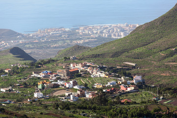 Fototapeta na wymiar Southern side of Tenerife island with small villages at the mountains slopes and the Atlantic coast, aerial view from mirador. Canary islands, Spain, Europe