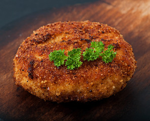 Chicken cutlet on an old wooden background, food.