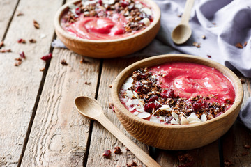 Smoothies bowl with granola, fruits and nuts
