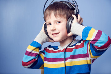 European boy listening music with headphones.