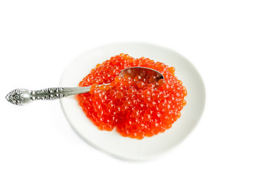 Red caviar on a platte, isolated on white background, close up
