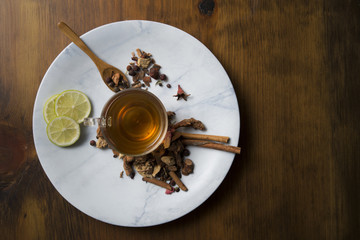 Food background with different black and green dry tea, rose buds cup of hot tea