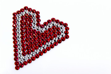 Precious Sparkling Rhinestones Red and Crystal Colors, Folded Heart Shaped, on a White Background.