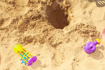 Fototapeta na wymiar Summer toys lying on sand.
