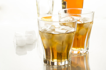 whiskey with ice in glass glasses