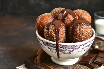 Stack of homemade fried vanilla donut with cinnamon,sugar and chocolate sauce.