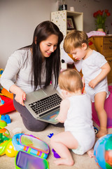 mother and children looking at laptop