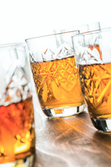 cognac in crystal wine glasses on a wooden table