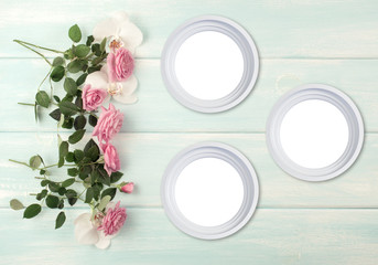 Wooden background with frames, roses and orchid flowers
