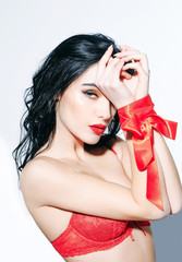 sexy woman with red lips, long hair in bra, ribbon