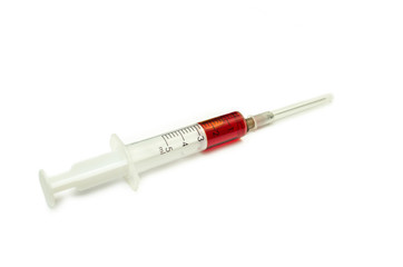 Fototapeta premium syringe with a drop of blood isolated on white background