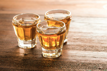 whiskey with ice on a wooden table