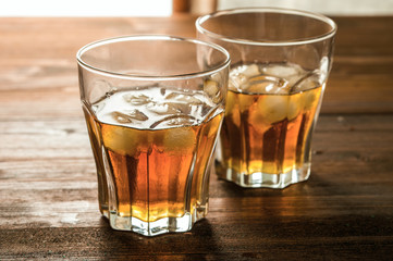 whiskey with ice on a wooden table