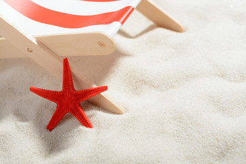 Red starfish near a lounger on the beach