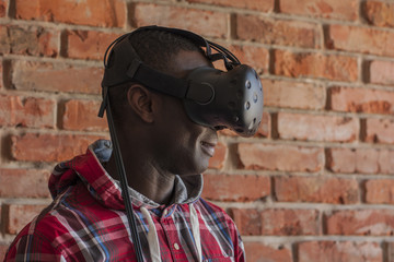Obraz premium Man wearing virtual reality device. Headset. Glasses with virtual screen. Young man touch something using modern glasses with virtual screen.