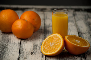 Orange fruit cut and orange juice on wooden table background,