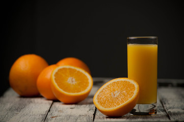 Orange fruit cut and orange juice on wooden table background,