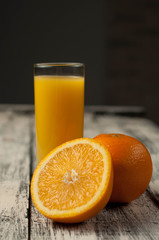 Orange fruit cut and orange juice on wooden table background,