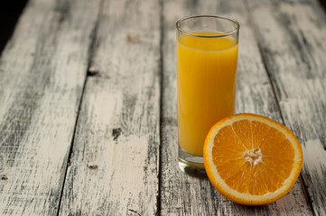 Orange fruit cut and orange juice on wooden table background,