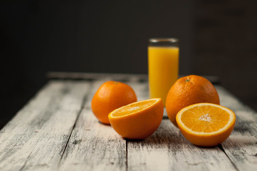 Orange fruit cut and orange juice on wooden table background,