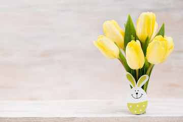 Yellow tulips, spring flowers and Easter decoration.