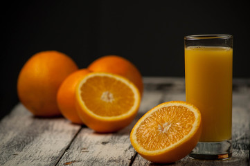 Orange fruit cut and orange juice on wooden table background,