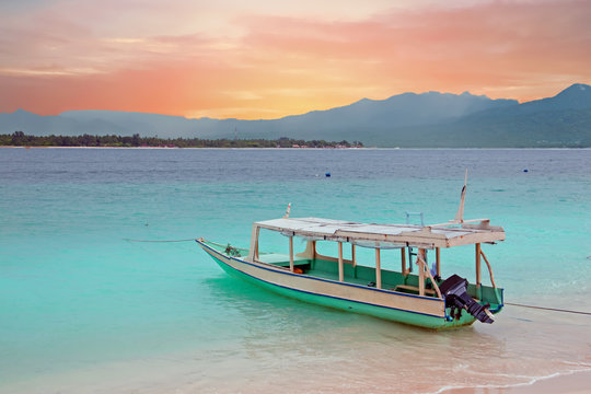 Fototapeta Traditional boat on Gili Meno island beach, Indonesia at sunset