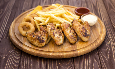 Chicken wings for beer and other snacks on a wooden background