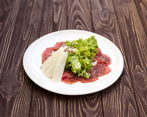 Meat appetizer on wooden background