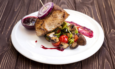 Juicy steak medium rare beef with spices and grilled vegetables