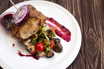 Grilled pork steak with vegetable on wood table
