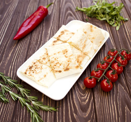 Armenian bread lavash fried in a pan . Lavash sandwich with chees