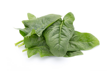 Fresh leaves of spinach on the white background.