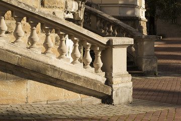 Fototapeta na wymiar Plaster beige balusters on stone stairs