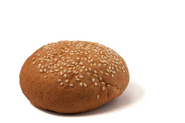 Hamburger bun with sesame seeds isolated on a white background