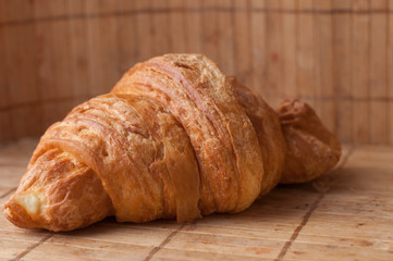 Tasty croissants on background
