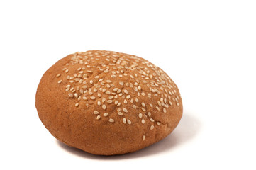 Hamburger bun with sesame seeds isolated on a white background